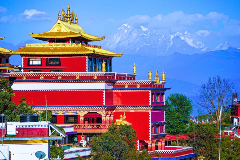 Thrangu Tashi Yangtse Buddhist Monastery in Namobuddha, Nepal, with snow-capped Himalayan mountains background.