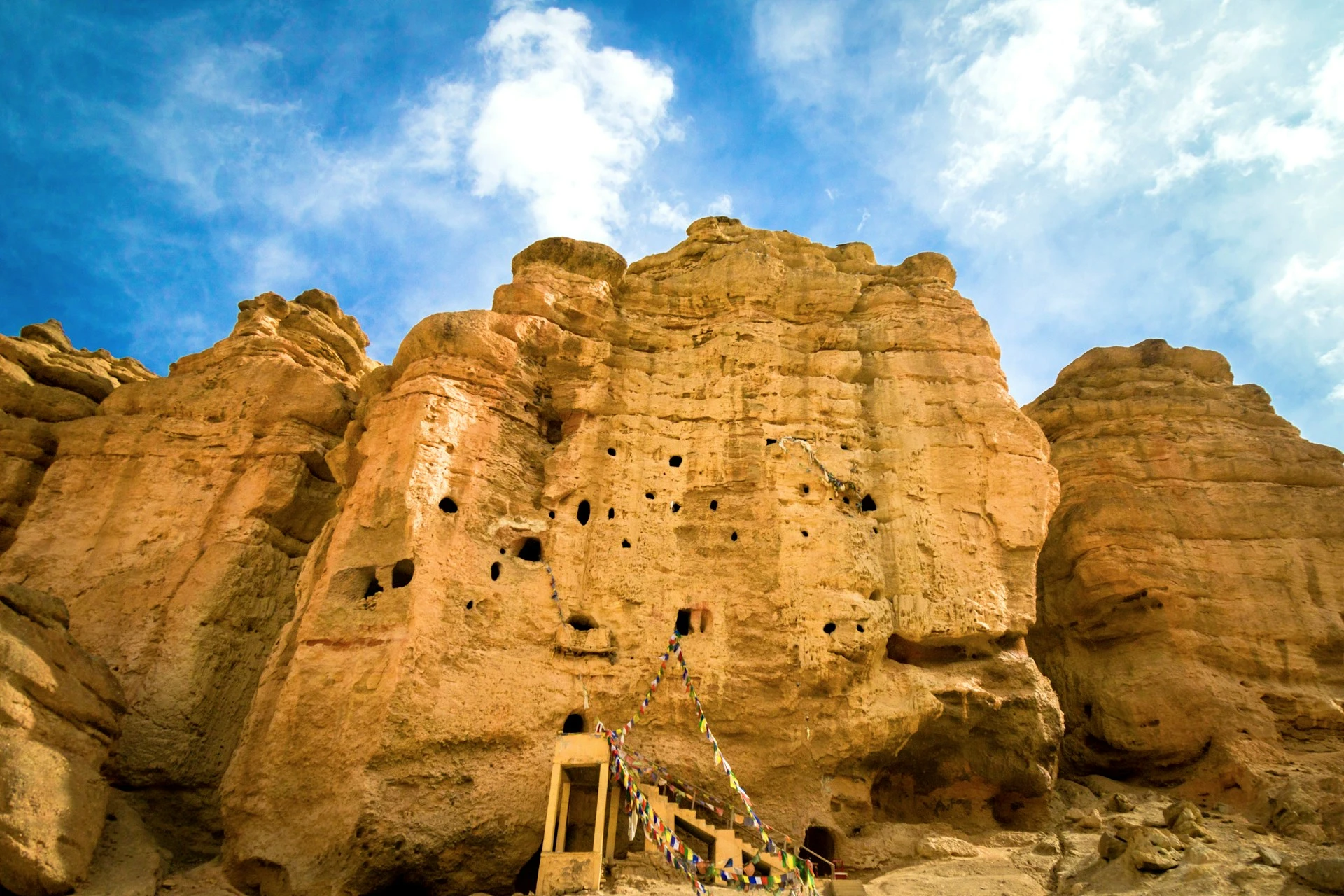 The ancient multi-story Jhong Cave carved into a desert cliff in Upper Mustang, Nepal