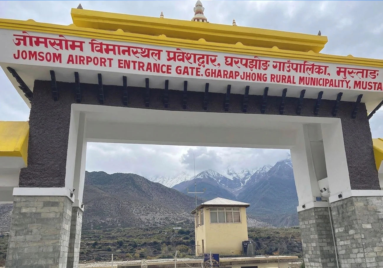Jomsom Airport entrance gate in Gharapjhong Rural Municipality, Mustang, with snow peaks behind the arch.
