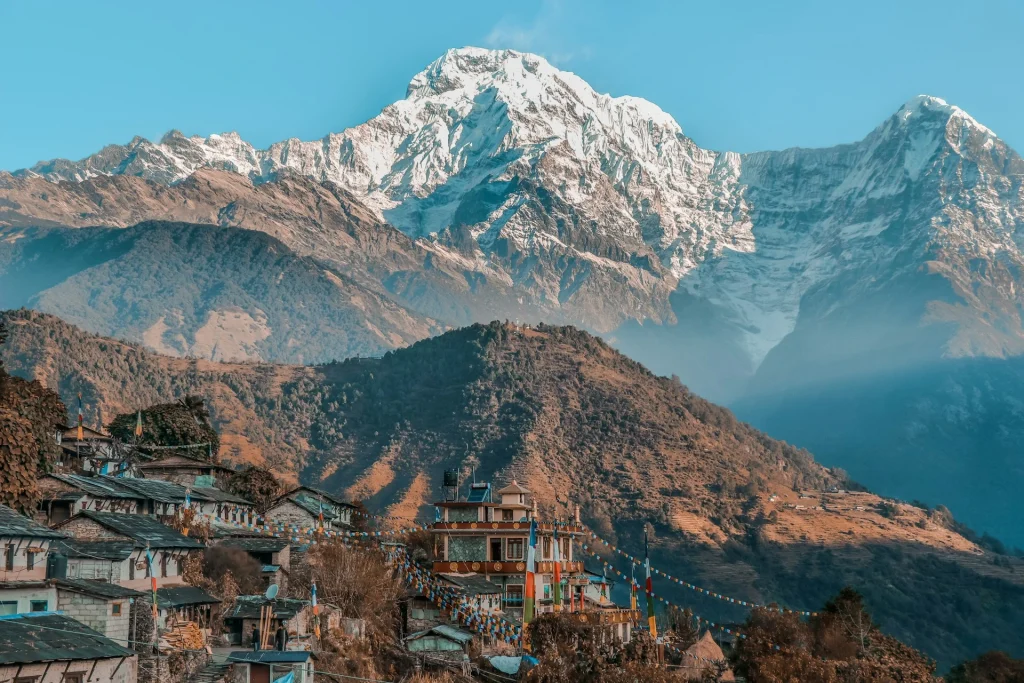 Ghandruk village, Kaski District, Nepal, featuring traditional stone houses set against the snow-capped peaks of Annapurna South and the Himalayas.